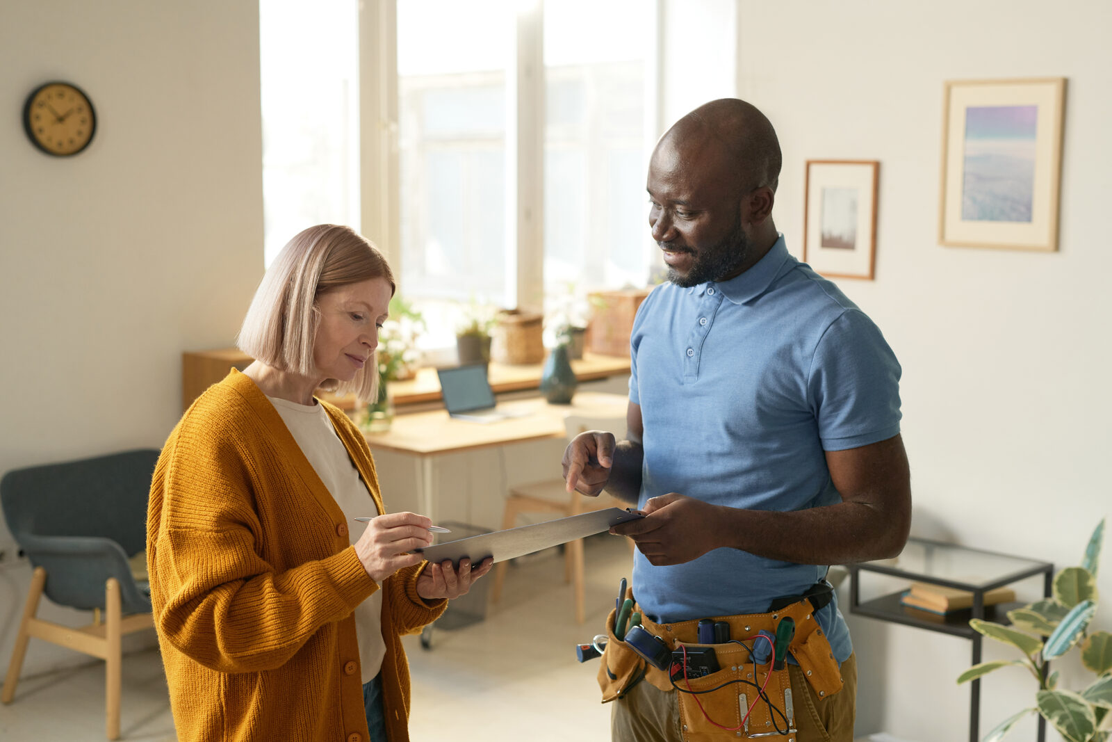 Contractor presenting a professional estimate to homeowner on tablet